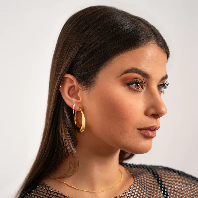 MILA jewelry worn together: gold-tone hoop earrings and a fine necklace
